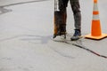The sealing of a joint crack in asphalt surface restoration work asphaltic joint sealant Royalty Free Stock Photo