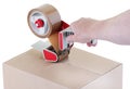 Sealing a shipping cardboard box with adhesive tape dispenser Royalty Free Stock Photo