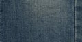 Seam blue denim cotton jeans fabric texture background Royalty Free Stock Photo