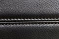 the seam at the junction of two pieces of black leather Royalty Free Stock Photo