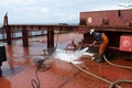 seaman onboard ship washing on deck Royalty Free Stock Photo