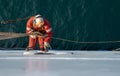 Seaman ship crew working aloft at height derusting and getting vessel ready for painting Royalty Free Stock Photo