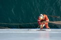 Seaman ship crew working aloft at height derusting and getting vessel ready for painting Royalty Free Stock Photo