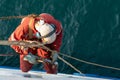 Seaman ship crew working aloft at height derusting and getting vessel ready for painting Royalty Free Stock Photo