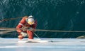 Seaman ship crew working aloft at height derusting and getting vessel ready for painting