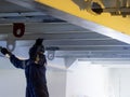 Seaman ship crew working on deck painting the at aft manouvering station Royalty Free Stock Photo