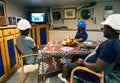 Seamen crew onboard a ship or vessel having fun watching TV Royalty Free Stock Photo