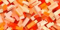 A seamless abstract background of overlapping rectangular blocks in vibrant orange, red, and peach