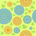 Seamless abstract blossoms yellow and blue with green leaves on light green Royalty Free Stock Photo