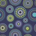 Seamless abstract pattern green, yellow and turquoise circles and dots on dark blue. Kaleidoscope background Royalty Free Stock Photo