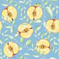 Seamless apples pattern with leaves. Cut red and yellow apples, halves on a blue background. Royalty Free Stock Photo