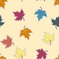 Seamless autumnal pattern with the image of colored maple leaves on a light background