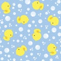 Seamless background with cute baby rubber ducks and bubbles