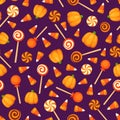 Seamless background with Halloween candies on purple. Vector illustration. Royalty Free Stock Photo