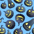 Seamless background for Halloween, different pumpkins with luminous faces on a blue background