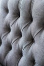 Seamless background texture close up of a grey sofa back with button detail on a thick cloth. Royalty Free Stock Photo