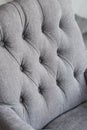 Seamless background texture close up of a grey sofa back with button detail on a thick cloth. Royalty Free Stock Photo