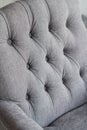 Seamless background texture close up of a grey sofa back with button detail on a thick cloth. Royalty Free Stock Photo