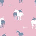 Seamless background of silhouettes of unicorns on pinc background