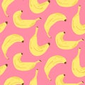 Seamless banana pattern on pink background in cartoon style. Ripe yellow bananas in the peel. Royalty Free Stock Photo