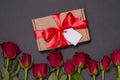 Valentines day gift ribbon bow tag, seamless black background red roses, free copy text space Royalty Free Stock Photo