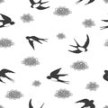 Seamless black and white pattern with flying swallows and clouds.