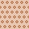Seamless brown and beige vector graphic of stylized four petal flower arranged in diagonal rows