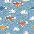 Seamless childish pattern with colorful airplanes and clouds for kids