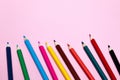 Seamless colored rainbow pencils row with wave on lower side, several arrangements, on pink paper. Concept of free space, Royalty Free Stock Photo