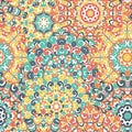 Seamless colorful ethnic pattern with mandalas in oriental style. Round doilies with green, red, yellow, orange curls Royalty Free Stock Photo