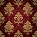 Seamless damask pattern with gold ornate floral designs on a deep maroon background Royalty Free Stock Photo