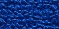 Seamless dark sapphire blue pile of small stone pebbles background texture Royalty Free Stock Photo