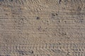 Seamless dirt road texture background. Tracks of cars on the san