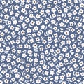 Seamless ditsy floral pattern in vector. Small white flowers on a blue background.