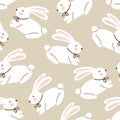 Seamless Easter pattern with white bunnies on a beige background. Royalty Free Stock Photo