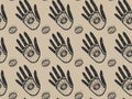 Seamless elegant magic pattern of black ornamental hands with all-seeing eyes inside the palms and the outside on a gold backgroun