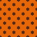 Seamless floral ditsy Halloween pattern with small black daisies flowers on orange background. Elegant holiday print for fabric