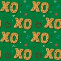 Seamless gingerbread XO phrase cookie. Christmas kiss and hug. Pattern,green background. Festive homemade sweets. Vector