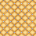 Seamless golden quilted background with pins.