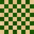 Green and tan checkered chess board background. Polished marbled stone textured squares. Seamless.