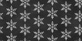 Seamless Grunge Pattern of Chalk Drawn Sketches White Snowflakes on Black Chalkboard Backdrop Royalty Free Stock Photo