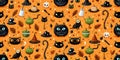 Seamless Halloween pattern with black cats, pumpkins, witch hat and candies. Cute cartoon vector background. Royalty Free Stock Photo