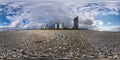 360 seamless hdri panorama view on stones and pebbles seashore or ocean with skyscrapers with blue sky and good weather in