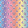 Seamless holographic pattern of rainbow flowers, on a gradient colored background
