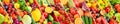 Seamless horizontal pattern multi-colored vegetables and fruits separated sloping vertical lines