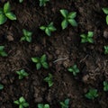 A seamless pattern of fertile soil with some green sprouts