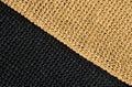 Seamless knitted pattern from black and beige yarn. Hand knitted Royalty Free Stock Photo