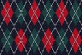 Seamless knitted pattern with red and green rhombuses on a navy background Royalty Free Stock Photo