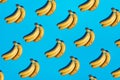 Seamless light blue background with ripe yellow bananas pattern and hard dark shadows. New color trend 2021. Minimal scene concept Royalty Free Stock Photo