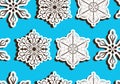 Seamless light blue pattern with three-dimensional paper snowflakes with shadow